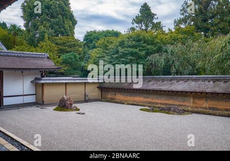 Der Blick auf den berühmten Zen-Garten des Ryoan-ji-Tempels - die trockene Landschaft (karesansui) Steingarten, bestehend aus 15 Steinen, umgeben von weißen Kieswellen. Stockfoto