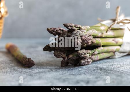 Grüner Spargel. Grüne Spargelbben auf grauem Betongrund Stockfoto