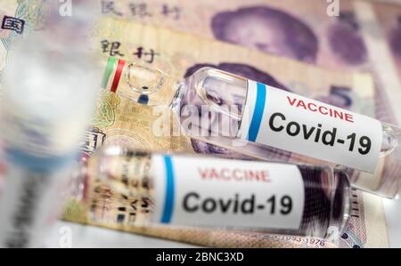 Coronavirus Fläschchen auf chinesischen Banknoten, konzeptionelles Bild Stockfoto