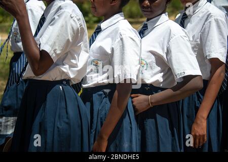 Mädchen in der Schlange für das Mittagessen an einer Sekundarschule in Kenia Stockfoto