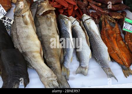 Snacks aus gesalzenem gepresstem getrocknetem Fischkaviar und verschiedenen Arten von gesalzenem Fisch sind auf der Theke des Ladens. Südlich der Ukraine Stockfoto