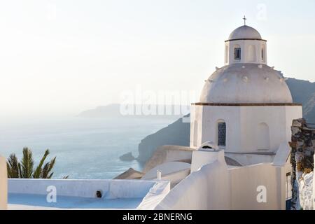 Kleine weiße typische griechische Kapelle 'Agios Minas' während der letzten Sonne am Meer entlang, Fira, Santorini, Griechenland Stockfoto