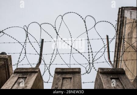 Auf der Oberseite einer Wand platzierter Konzertseil. Grauer wolkig Himmel Stockfoto