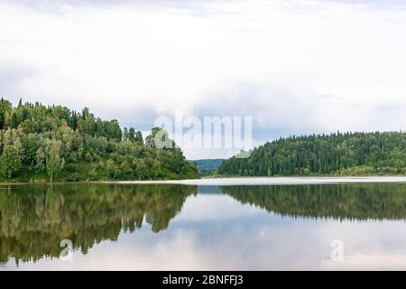 Großer See umgeben von Taiga bei bewölktem Wetter Stockfoto