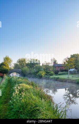 Kanalbrücke, Nebel und Hütte entlang des oxford-Kanals am frühen Morgen. Somerton, Oxfordshire, England Stockfoto