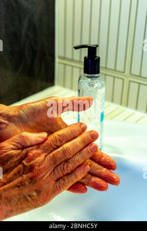 Person gründlich waschen Hände reiben mit Seife in der Spüle für Coronavirus-Schutz Stockfoto