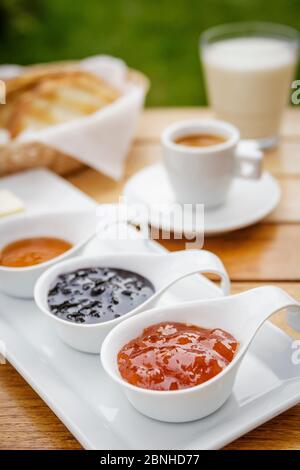 Pfirsich, Heidelbeere, Himbeere Erdbeermarmelade Kaffee Espresso Milch Toast zum Frühstück im Garten Stockfoto