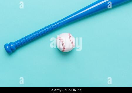 Blauer Baseballschläger und Ball auf blauem Hintergrund isoliert Stockfoto