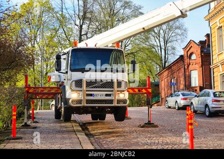 Hydraulischer LKW-Kran auf Stützen angehoben, hält den Kran stabil und ausgeglichen während des Betriebs. Vorderansicht. Helsinki, Finnland. 13.Mai 2020 Stockfoto