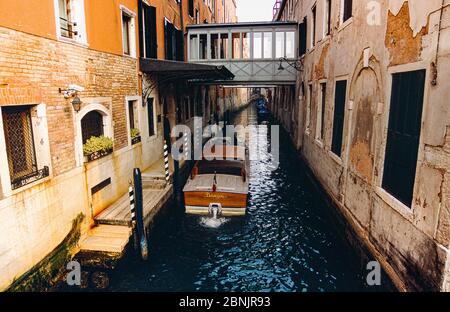 Blick auf den Kanal zeigt Hotel Danieli Eingang auf den Rio del Vin, mit einem Wassertaxi, historische Gebäude und Auswirkungen der Wassererosion. Venedig, Italien. Stockfoto