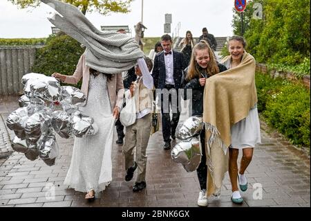 15. Mai 2020, Schleswig-Holstein, Stein: Hochzeitsgäste verlassen die Feierlichkeiten nach einer Trauung am Kieler Förde-Strand bei strömendem Regen. Familienfeiern sind aufgrund der Koronakrise nur bedingt möglich. Foto: Axel Heimken/dpa Stockfoto