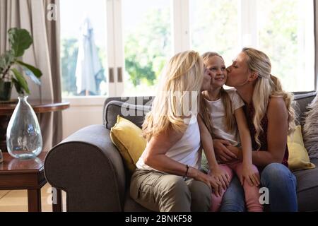 Kaukasische Frau mit ihrer Tochter und Mutter auf einer Couch sitzen Stockfoto