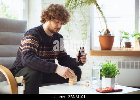 Porträt von Millennial Junge mit Retro-Stil, Treffen Dinge aus der Vergangenheit und Spaß haben. Generation of Digital Devices untersucht vergangene Unterhaltung der 90er Jahre. 90-s trendy Look, Jugend. Cola trinken. Stockfoto