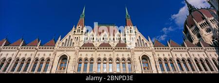 Panorama-Flachwinkelansicht der Hauptfassade des ungarischen Parlamentsgebäudes. Budapest, Ungarn Stockfoto