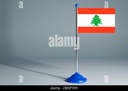 Die 3d-Darstellung realistische Nationalflagge des Libanon auf Stahlstange auf grauem isolierten Hintergrund. Leere Tischflagge , geeignet für Design, Mockup Stockfoto