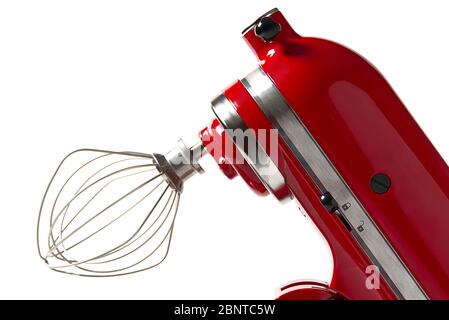 Stilvoller Roter Küchenmischer Mit Isoliertem Schnittpfad Auf Weißem Hintergrund. Professioneller elektrischer Stahl-Mixer mit Metallbesen. Stockfoto