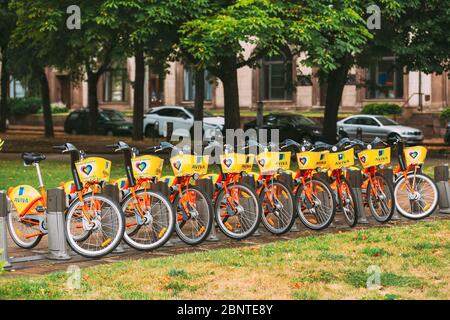 Vilnius, Litauen - 5. Juli 2016: Reihe von bunten Fahrräder AVIVA zu vermieten am städtischen Fahrrad-Parken In der Straße. Sommertag nach Regen Stockfoto