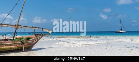 Sansibar, Tansania - 8. Februar. 2020: Holzboot am Strand mit atemberaubendem türkisfarbenem Wasser und Textraum Stockfoto