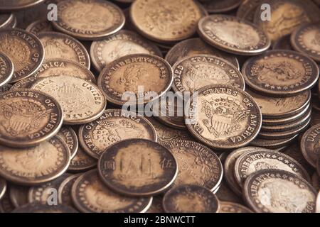 Antike Münzen der Vereinigten Staaten von Amerika mit Freiheitswort mit einigen chinesischen Münzen gemischt. Vollständiger Hintergrund. Geld von 1804. Stockfoto