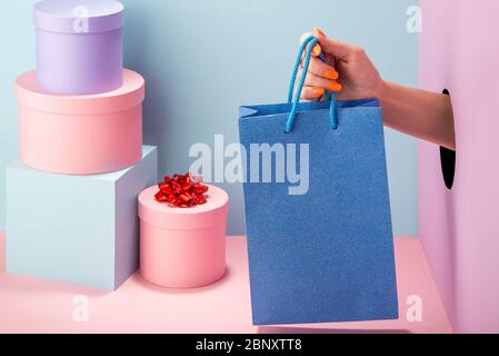 Frauenhand mit einem blauen Glitter-Beutel Stockfoto