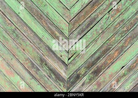 Hintergrund. Holzbretter mit abblätternder grüner Farbe Stockfoto