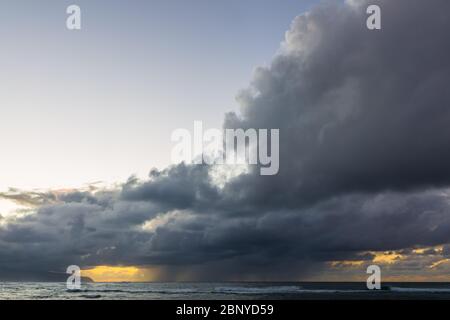 Bild von dunklen Wolken bei Dämmerung über dem Meer Stockfoto