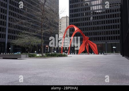 Blick auf einen leeren platz mit der leuchtend roten Flamingo-Skulptur des amerikanischen Künstlers Alexander Calder, die sich auf der Federal Plaza in Chicago befindet Stockfoto