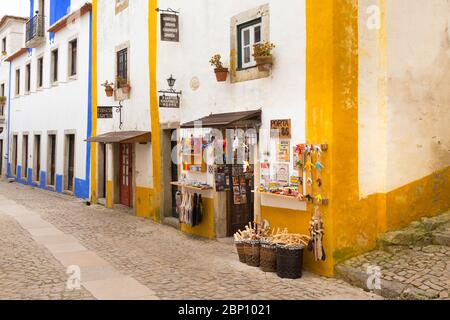 OBIDOS, PORTUGAL - 25. FEBRUAR 2017: Blick auf die mittelalterliche Stadt Obidos. Hauptstraße und Geschäfte. Stockfoto