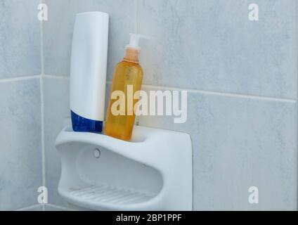 Shampoo Flaschen stehen auf Seifenspender im Bad. Es ist von Fliesen umgeben. Nahaufnahme. Stockfoto