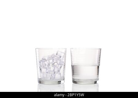 Eisschmelzkonzept mit einem Becher Glas voller Eis und einem zweiten Bild eines anderen Becher Glas halb voll Wasser, das das geschmolzene Eis zeigt Stockfoto