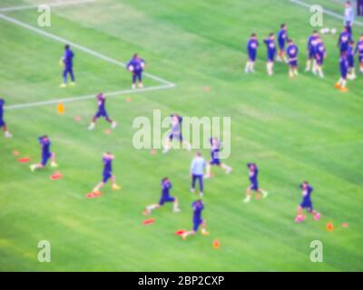 soccer player warm up in the green grass before the game start in big soccer stadium.-blurred picture.. Stockfoto