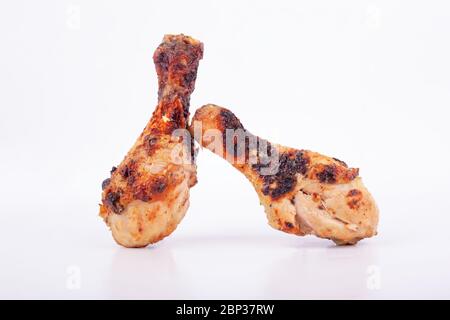 Zwei gebratene Hähnchenbeine auf einem isolierten weißen Hintergrund, gegrilltes Hähnchen. Stockfoto