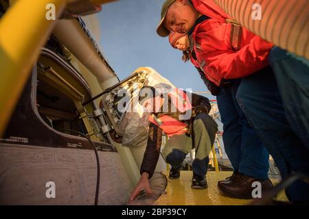 Boeing CST-100 Starliner Landing der Boeing-Astronaut Chris Ferguson, links, und die NASA-Astronauten Nicole Mann und Mike Fincke inspizieren das Boeing CST-100 Starliner kurz nachdem es in White Sands, New Mexico, Sonntag, 22. Dezember 2019 gelandet war. Die Landung schließt einen abgekürzten Orbital Flight Test für das Unternehmen ab, das noch mehrere Missionsziele für das NASA Commercial Crew Programm erfüllt. Die Raumschiff-Raumsonde startete auf einer United Launch Alliance Atlas V Rakete um 6:36 Uhr am Freitag, 20. Dezember aus dem Space Launch Complex 41 in Cape Canaveral Air Force Station in Florida. Stockfoto