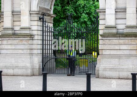 Dublin, Irland. Mai 2020. St. Stephen's Green Park Warden öffnet die Eingangstore am Fusilier's Arch. Stockfoto