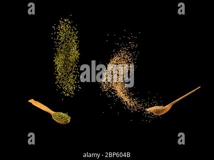 Null-Schwerkraft-Food-Konzept. Mungbohnen und Senfkörner, die isoliert auf schwarzem Hintergrund plätschern. Gesunde Ernährung. Stockfoto