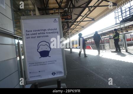 Ein Schild, das Passagiere aufzeigt, am Bahnhof Clapham Junction in London eine Gesichtsmaske zu tragen, da die Zugverbindungen im Zuge der Lockerung der Lockdown-Beschränkungen für Coronavirus zunehmen. Stockfoto