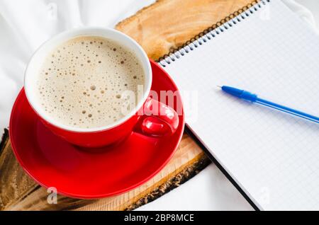 Tasse heißen Cappuccino, Croissant und Schokolade im Bett, Leer Notebook für den Hinweis. Selektive konzentrieren. Kopieren Sie Platz. Stockfoto