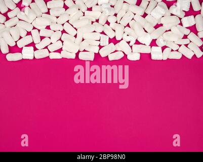 Weißer Schaum Füllstoff für Befüllung Pakete während des Transports auf einem rosa Hintergrund, kopieren Raum Stockfoto