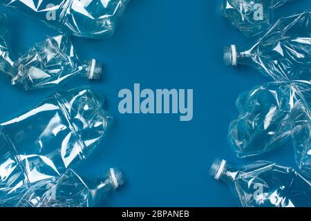 Viele gebrauchte Plastikflaschen auf blauem Hintergrund. Das Konzept der Verschmutzung des Planeten und der Ozeane durch Plastikmüll. Kopierraum. Stockfoto