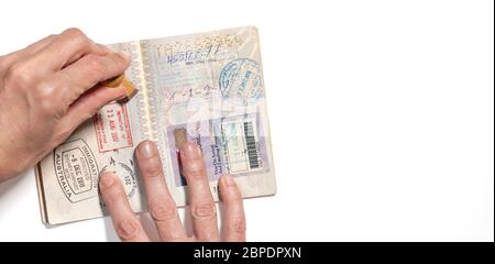 Stempeln von Visa auf Passseiten mit vielen Visa-Stempeln. Stockfoto