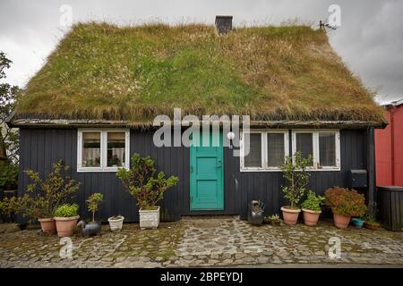 TORSHAWN, FÄRÖER, Dänemark - 21 August 2018: Typisches Haus mit Grasdach in Färöer Inseln, Dänemark. Stockfoto