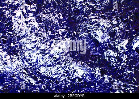 Helle weihnachten und Neujahr blauen Hintergrund. Textur aus klassisch blauer glänzender Folie. Stockfoto