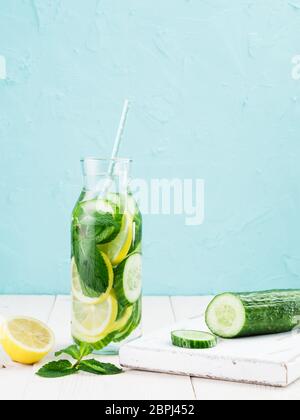 Infundiert detox Wasser mit Gurke, Zitrone und Minze im Glas Flasche auf weißer Tisch. Diät, gesunde Ernährung, Gewichtsreduktion Konzept. Platz kopieren Stockfoto