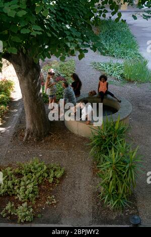 Besucher am Brunnen in Gärten l'Espace Van Gogh Kulturzentrum.das ehemalige Krankenhaus von Arles.Bouches-du-Rhone.Provence-Alpes-Cote d'Azur.Frankreich Stockfoto