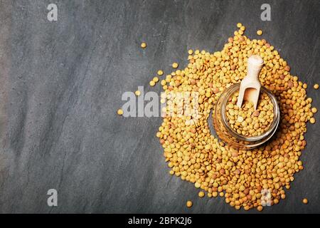 Roh Linsen auf Schwarz Stein Hintergrund. Gesunde vegetarische Essen Konzept. Superfoods. Ansicht von oben, kopieren. Linsen sind reich an komplexen Kohlenhydraten, f Stockfoto