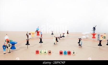 Büro Arbeit abstraktes Foto. Verdrahtete Punkte auf Holzfläche mit kleinen Mannfiguren. Stockfoto