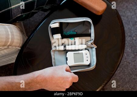 Overhead shot für ältere Diabetiker mann Vorbereitung einer Blutglukose Test zu Hause. Stockfoto