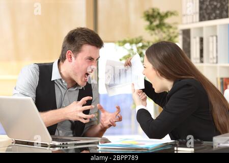 Zwei böse Geschäftsleute streiten wütend zeigt ein negatives Wachstum Diagramm im Büro Stockfoto