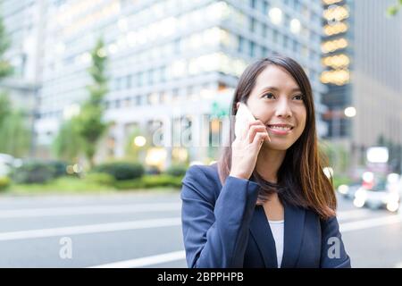 Geschäftsfrau mit Handy in Tokio Stadt sprechen Stockfoto