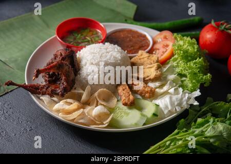 Nasi Lemak kukus mit Wachtel Fleisch, beliebten traditionellen malaysischen lokalen Essen. Stockfoto